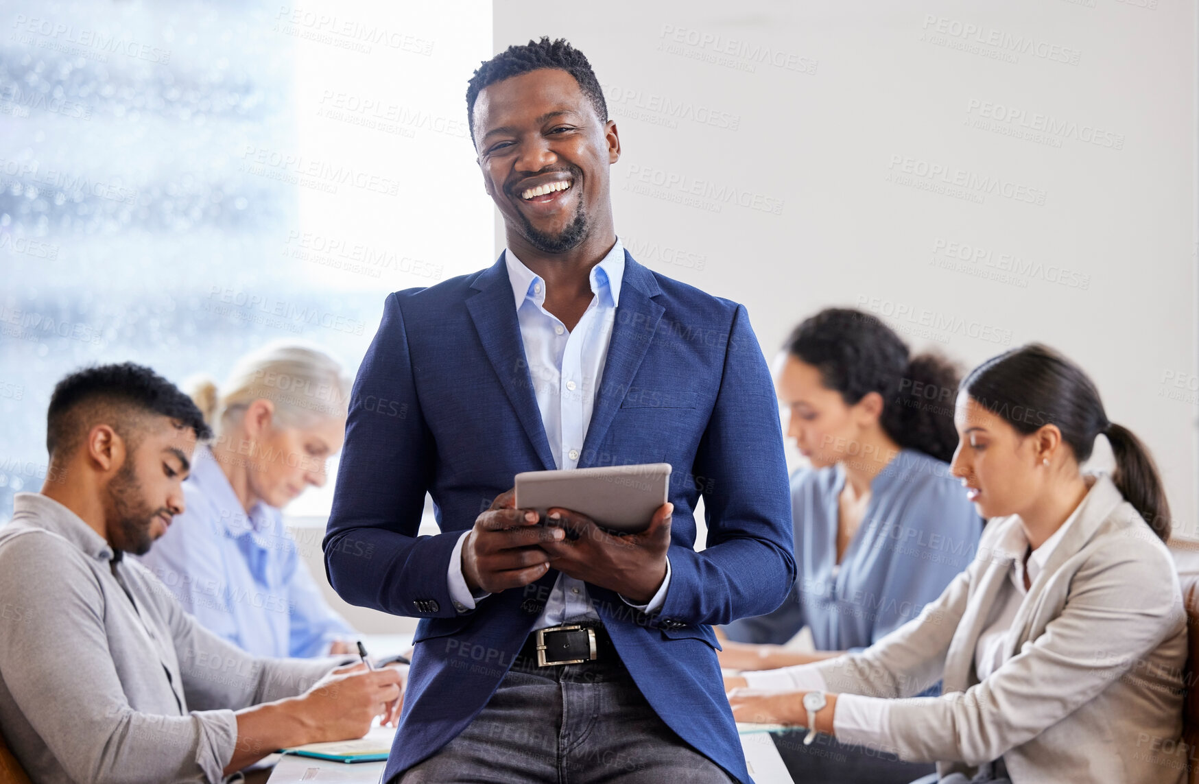 Buy stock photo Shot of a confident young businessman working in a modern office