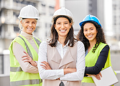 Buy stock photo Cropped portrait of three attractive female engineers standing with their arms folded on a construction site