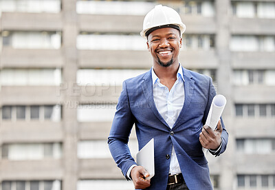Buy stock photo Cropped portrait of a handsome young male engineer holding blueprints and a tablet while standing on a construction site