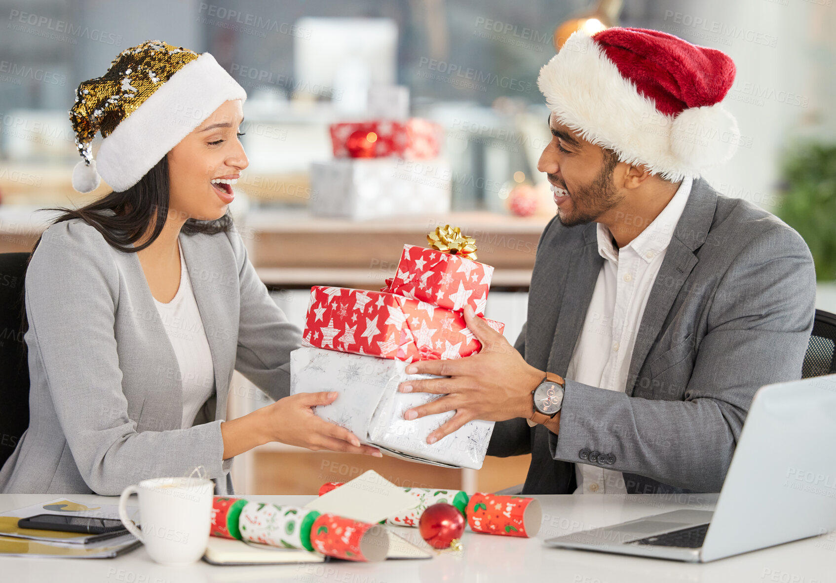 Buy stock photo Christmas, gift and surprise with business people at desk of office in December for festive celebration together. Box, present and wow with employee team in workplace for holiday season excitement