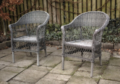 Buy stock photo Garden chairs on a patio in a backyard garden in summer. Old, rustic, and vintage garden furniture is used for relaxation and sitting while relaxing out in nature. Peaceful and quiet area in a yard