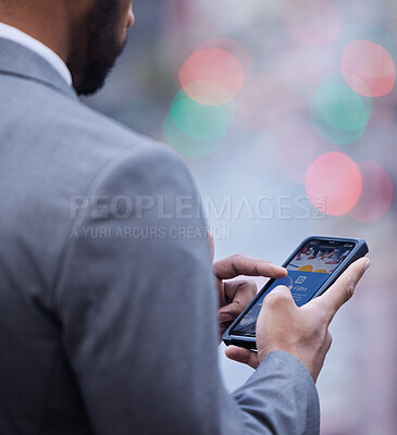 Buy stock photo Cropped shot of an unrecognisable businessman standing alone and using his cellphone