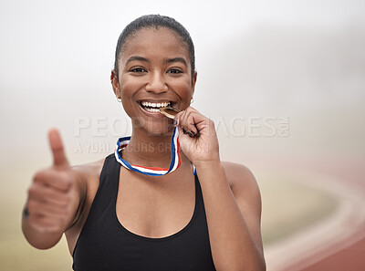 Buy stock photo Shot of a young female athlete giving the thumbs up while biting her medal
