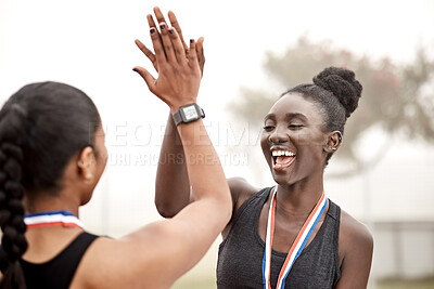 Buy stock photo Shot of two athletes high fiving one another