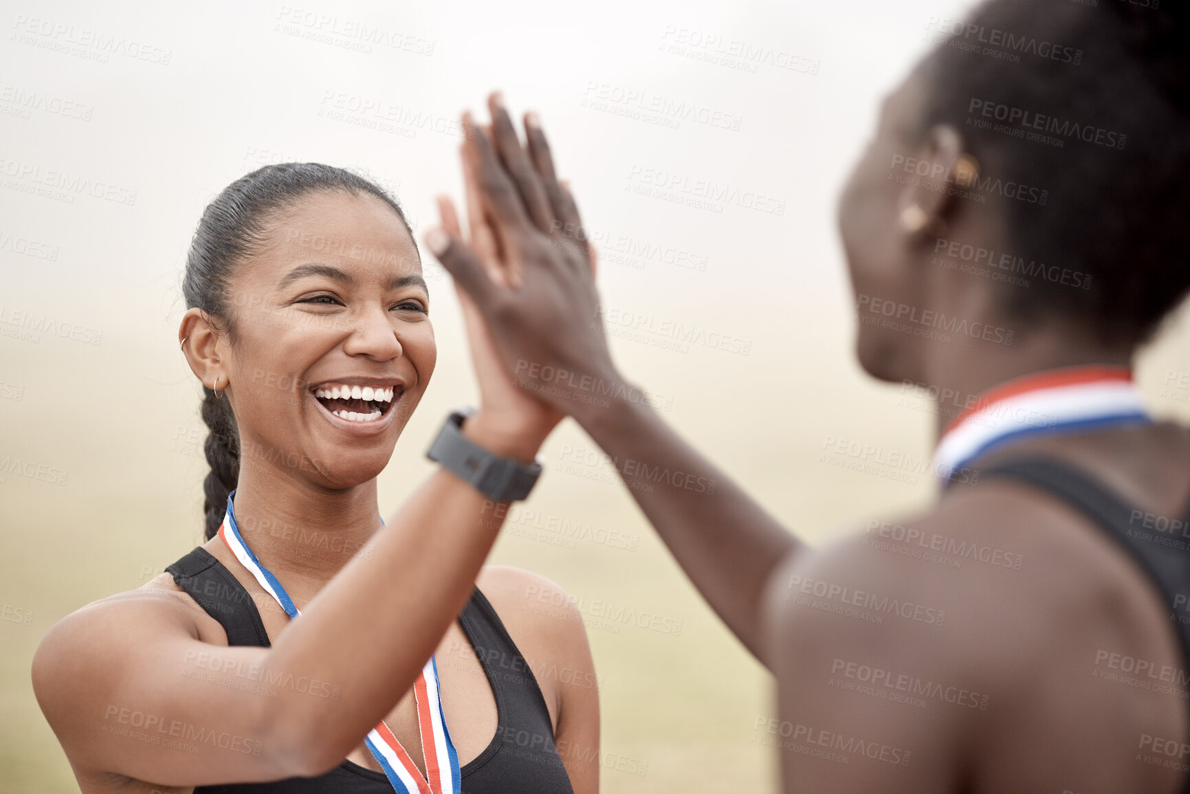 Buy stock photo Shot of two athletes high fiving one another