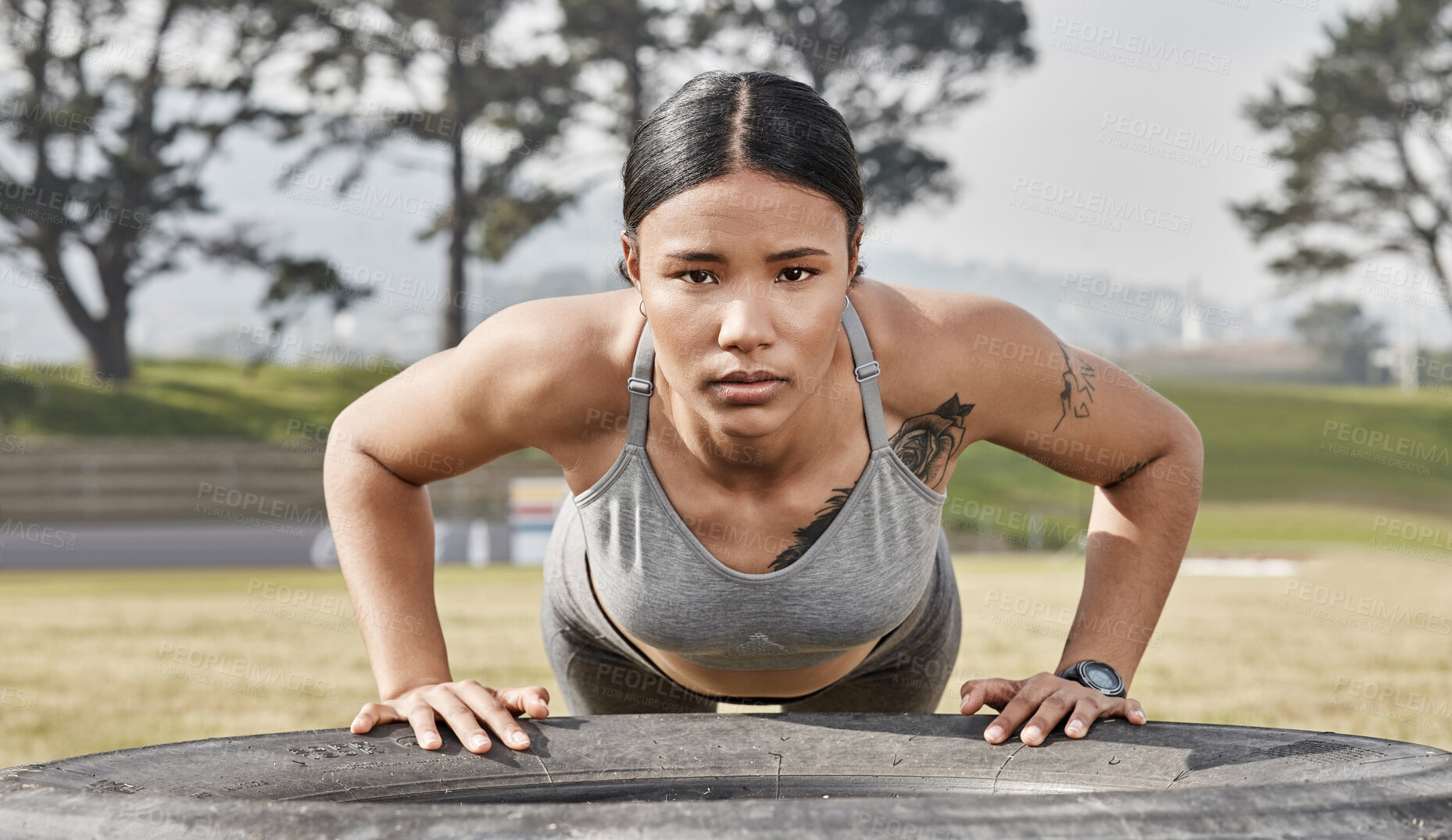 Buy stock photo Shot of a athletic young woman exercising outdoors