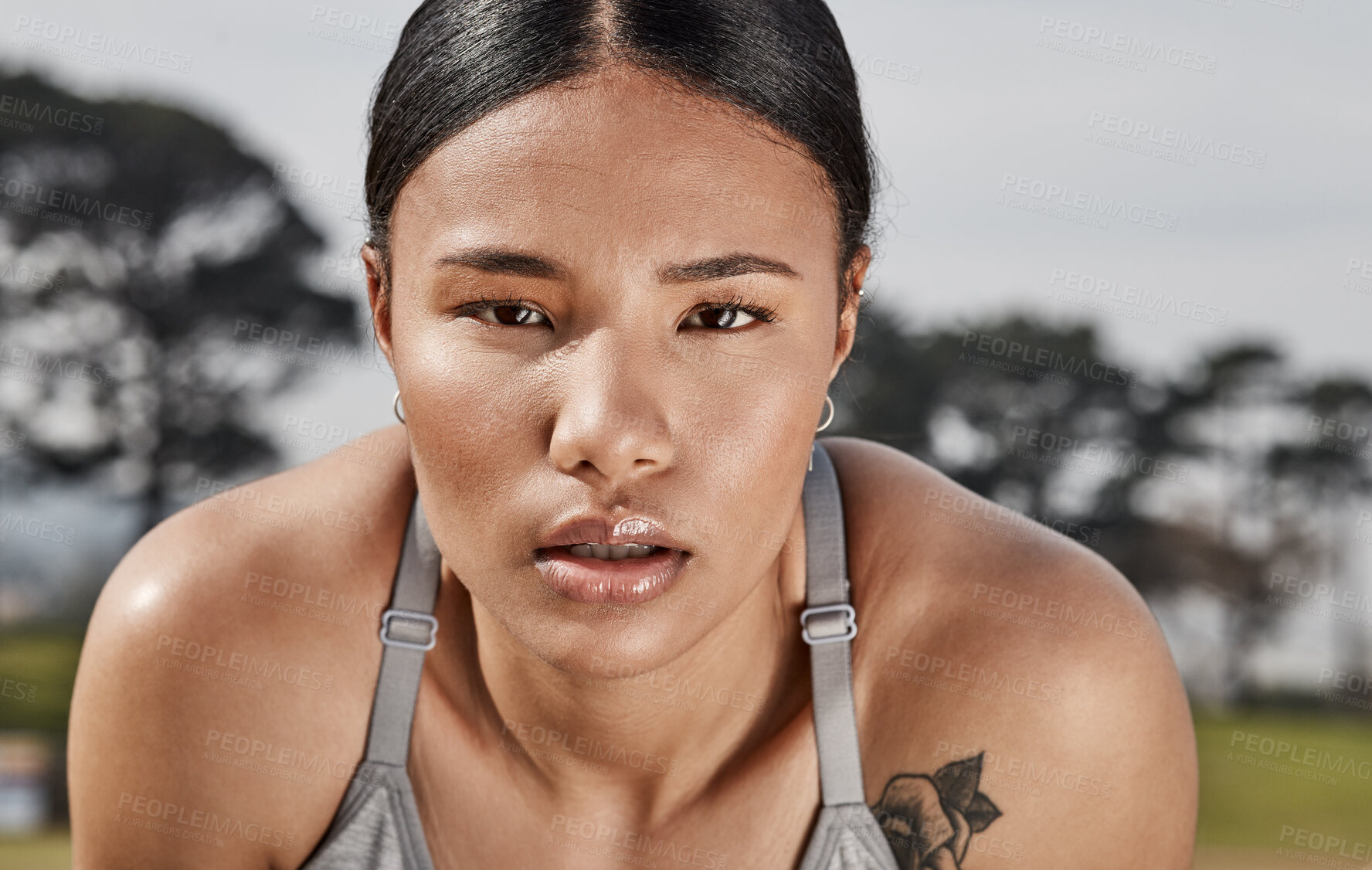 Buy stock photo Shot of a sporty young woman exercising outdoors