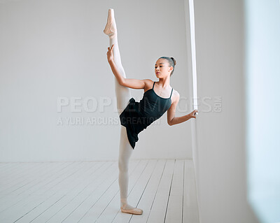 Buy stock photo Full length shot of an attractive young female ballerina practicing in her dance studio