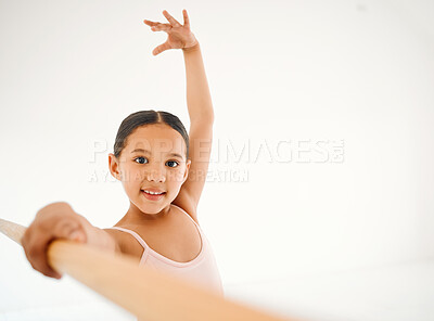 Buy stock photo {Portrait of a little girl practicing ballet at a barre in a dance studio