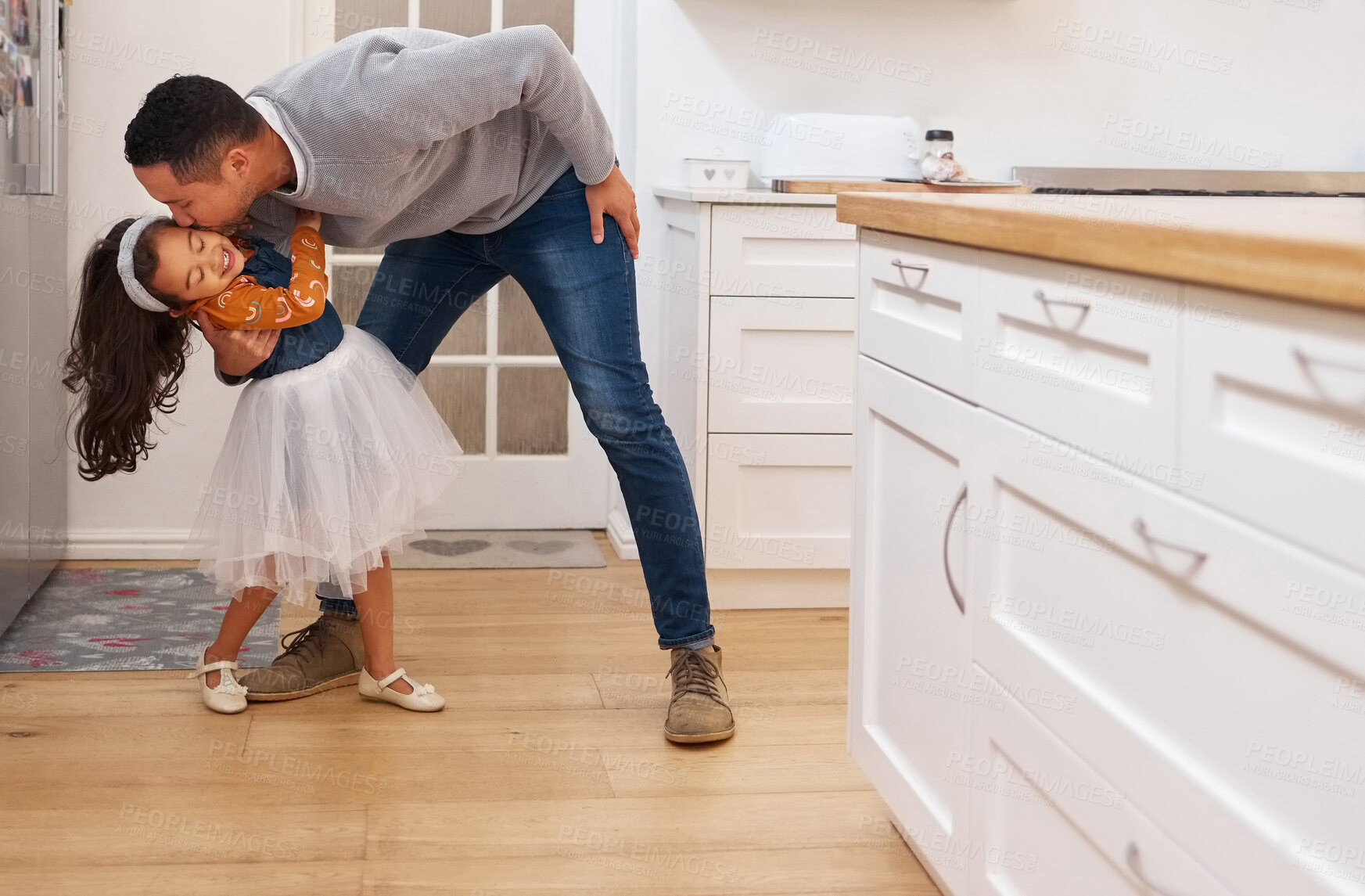 Buy stock photo Shot of a father giving his daughter a kiss on the cheek