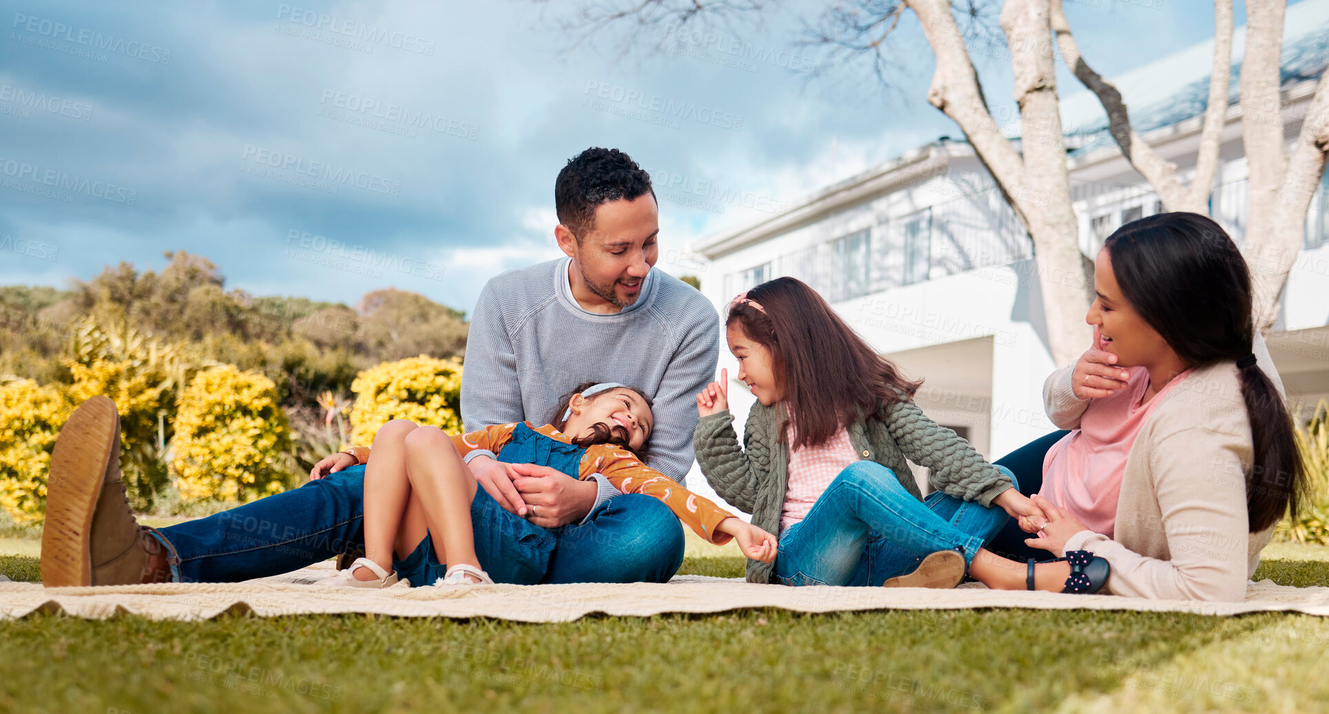 Buy stock photo Picnic, laughing and happy family relax, play or enjoy outdoor bonding together, tickle games and nature fun. Summer, backyard and parents for dad, mom and kids outside in park with father and mother