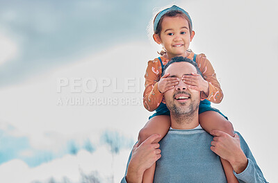 Buy stock photo Shot of a little girl covering her father's eyes while sitting on his shoulders outdoors