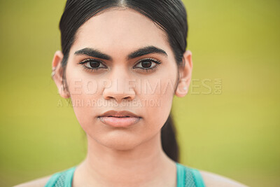 Buy stock photo Cropped portrait of an attractive young sportswoman standing outside against a green background
