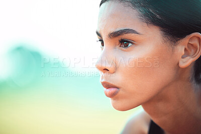 Buy stock photo Cropped shot of an attractive young sportswoman looking focused while taking up her starting position on track