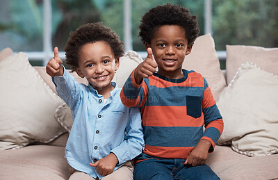 Buy stock photo Portrait of two little boys showing thumbs up at home