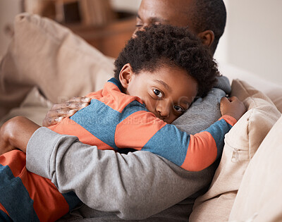 Buy stock photo Love, portrait and boy hugging his father while relaxing on sofa in the living room of their home. Care, safety and scared African child embracing his dad for comfort or bonding in their family house