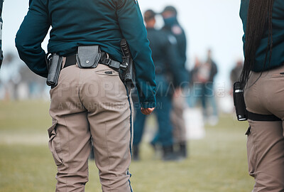 Buy stock photo Security, strike or protest with police officer in park for law enforcement, protection or safety. Brave, uniform or government with people in street for demonstration rally, human rights or control 