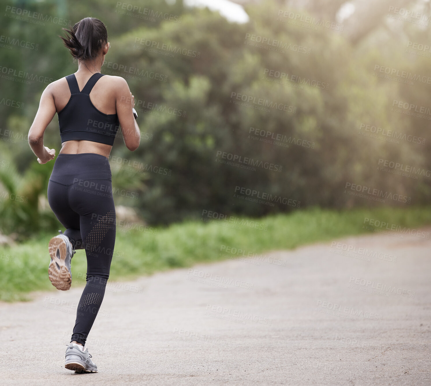 Buy stock photo Running in nature, woman from back and fitness, mockup space and trees on healthy workout on path. Exercise, health and wellness, girl runner on forest path with commitment to training on outdoor run