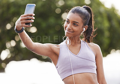 Buy stock photo Selfie, earphones and woman athlete outdoor for health, wellness or body workout listening to music. Smile, nature and Indian female person with photography picture for workout or training in park.