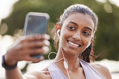 Buy stock photo Selfie, earphones and happy woman athlete outdoor for health, wellness or body workout listening to music. Smile, nature and female person with photography picture for workout or training in park.