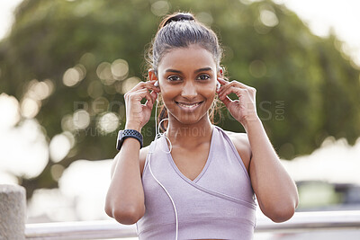 Buy stock photo Fitness, portrait of happy woman with earphones in park on workout break listening to music or podcast. Exercise, training and girl with headphones for radio streaming service while running in nature