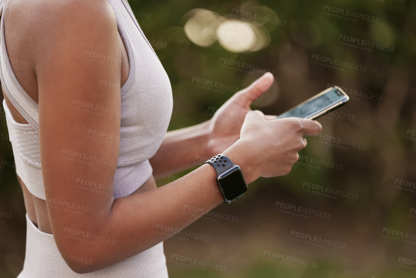 Buy stock photo Smartphone, hands and woman in park for fitness, exercise or wellbeing while texting, chat or browsing health tips. Person, arms and outdoors on cellphone in workout clothes for run, jog and training