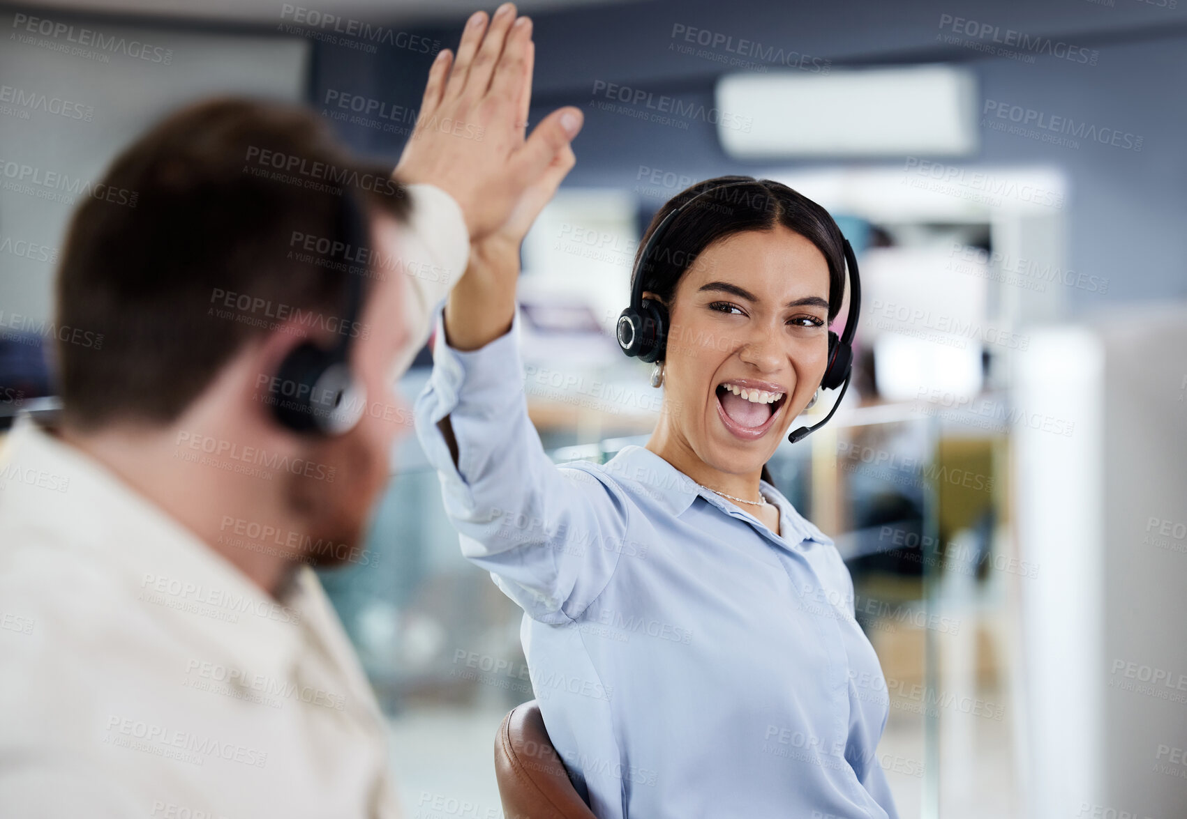 Buy stock photo Support, colleagues with headset and at their desk of a modern workstation office. Collaboration or teamwork, happiness or call center agents and coworkers celebrating for achievement together