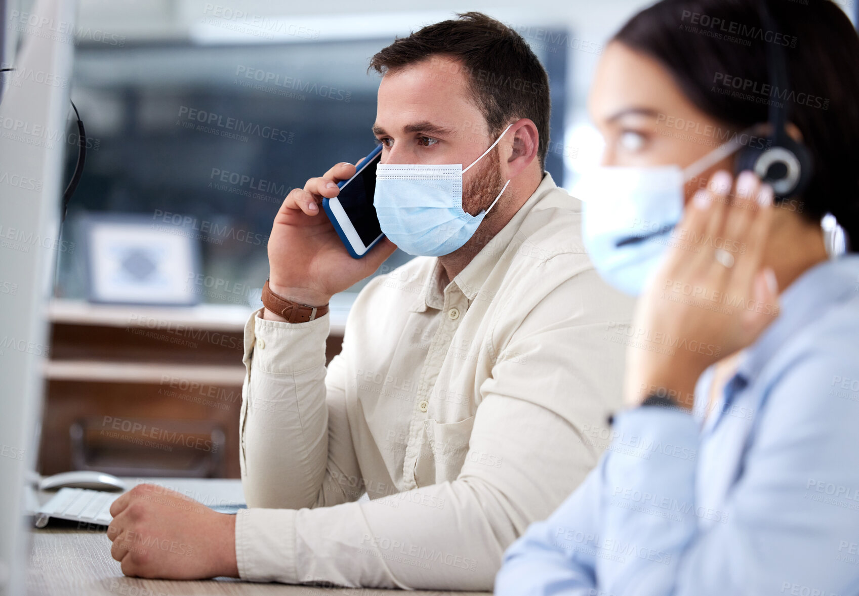 Buy stock photo Phone call, man and woman in callcenter with face mask, computer and headset at customer support agency. Help desk, telemarketing and client service team with ppe for safety, protection or compliance