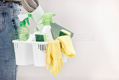 Buy stock photo Shot of a woman holding a basket of cleaning supplies against a white background