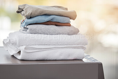 Buy stock photo Home, clothes on a washing machine and laundry day with a lens flare. Cleaning or hygiene, appliances or mockup space and folded clean pile of clothing on a wash dryer at a house for housework