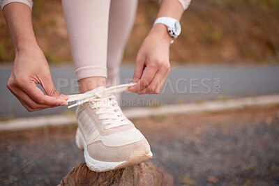 Buy stock photo Shot of an unrecognizable woman getting ready to exercise outside