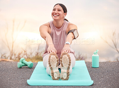 Buy stock photo Shot of a young female athlete stretching before a run in nature