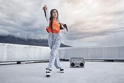 Buy stock photo Girl, dance and hip hop outdoor on city rooftop with music, speaker and cool gen z streetwear fashion. Woman, moving and dancer with creative energy on apartment balcony and urban style or freedom