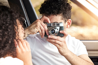 Buy stock photo Couple, photographer and car with memory for travel, sightseeing or capture together on road trip. Man and picture with woman with camera for photograph, moment or tour on outdoor journey in vehicle