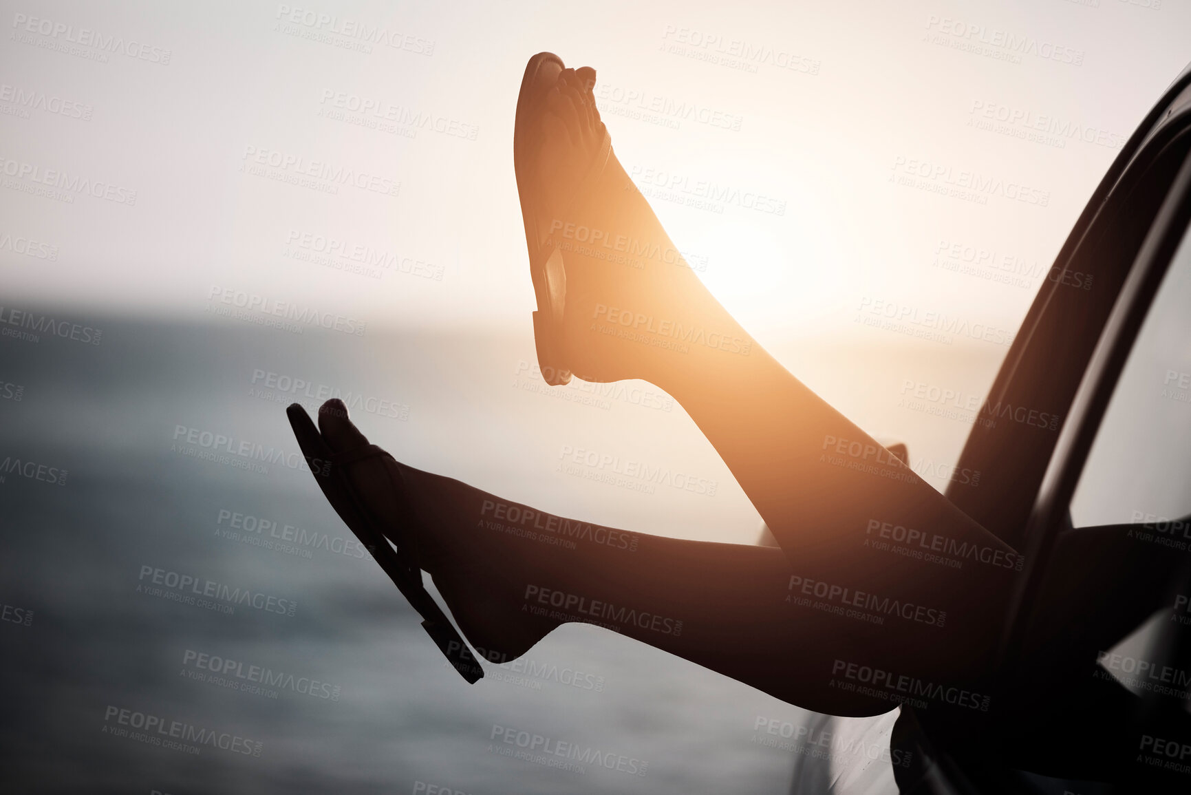 Buy stock photo Sunset, beach and feet in window of car on road trip for tropical holiday, vacation or adventure. Travel, freedom and person with shoes in vehicle to ocean or sea in summer to relax with peace