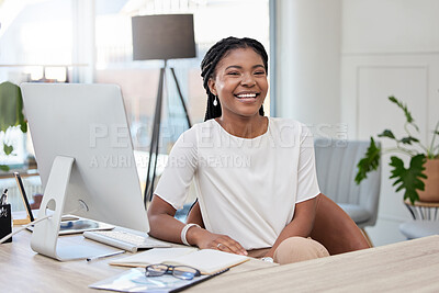 Buy stock photo Shot of a young businesswoman sitting at a desk in an office at work