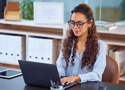 Buy stock photo Cropped shot of an attractive young businesswoman working on her laptop in the office