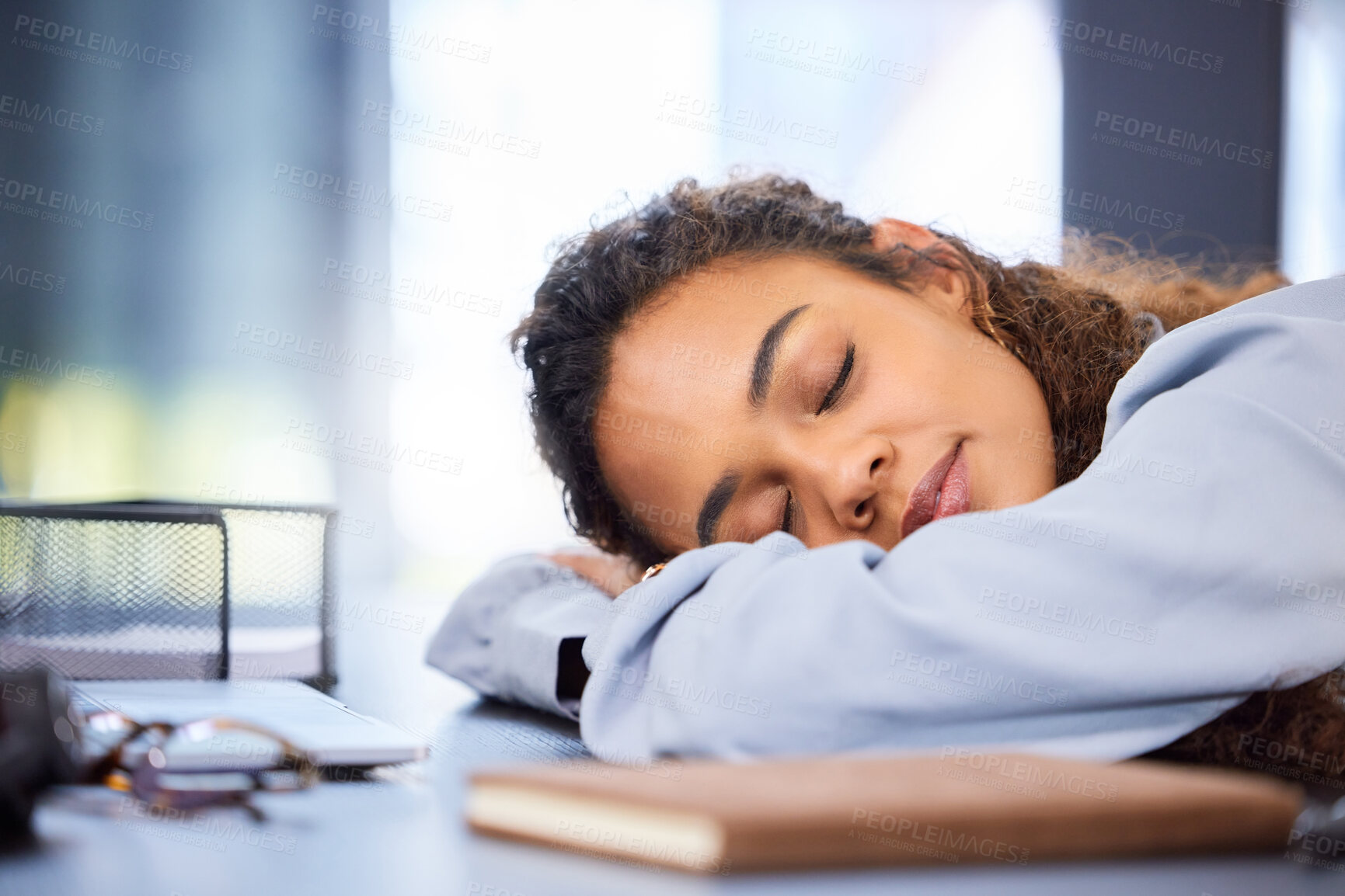 Buy stock photo Cropped shot of an attractive young businesswoman sleeping on her desk in the office