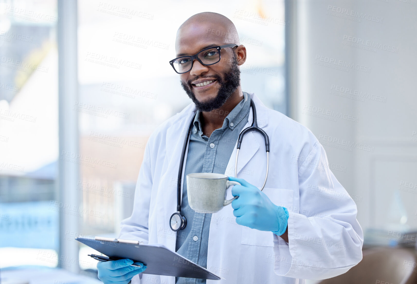 Buy stock photo Shot of a male doctor holding a hot beverage and a clipboard