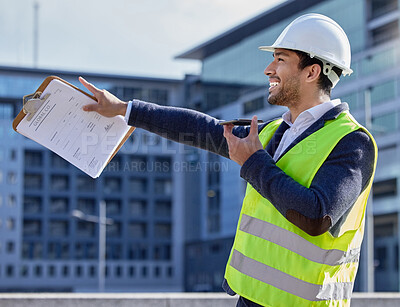 Buy stock photo Engineer, man and clipboard and pointing in construction site with phone call, smile and confident. Male person, project leader and hardhat in Dubai for building, architecture and development