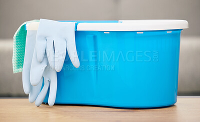 Buy stock photo Cleaning cloth, bucket and gloves on table with materials for washing, mopping and spring clean in living room. Housekeeping, chores and supplies for hygiene, sanitation and cleanliness in home