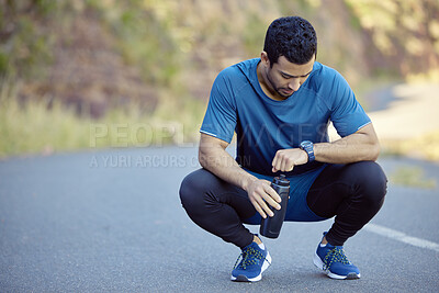 Buy stock photo Man, watch and tired athlete on break tracking training on mountain path for exercise, goals or check. Male person,  street and resting with heart rate pulse for marathon running, workout or healthy