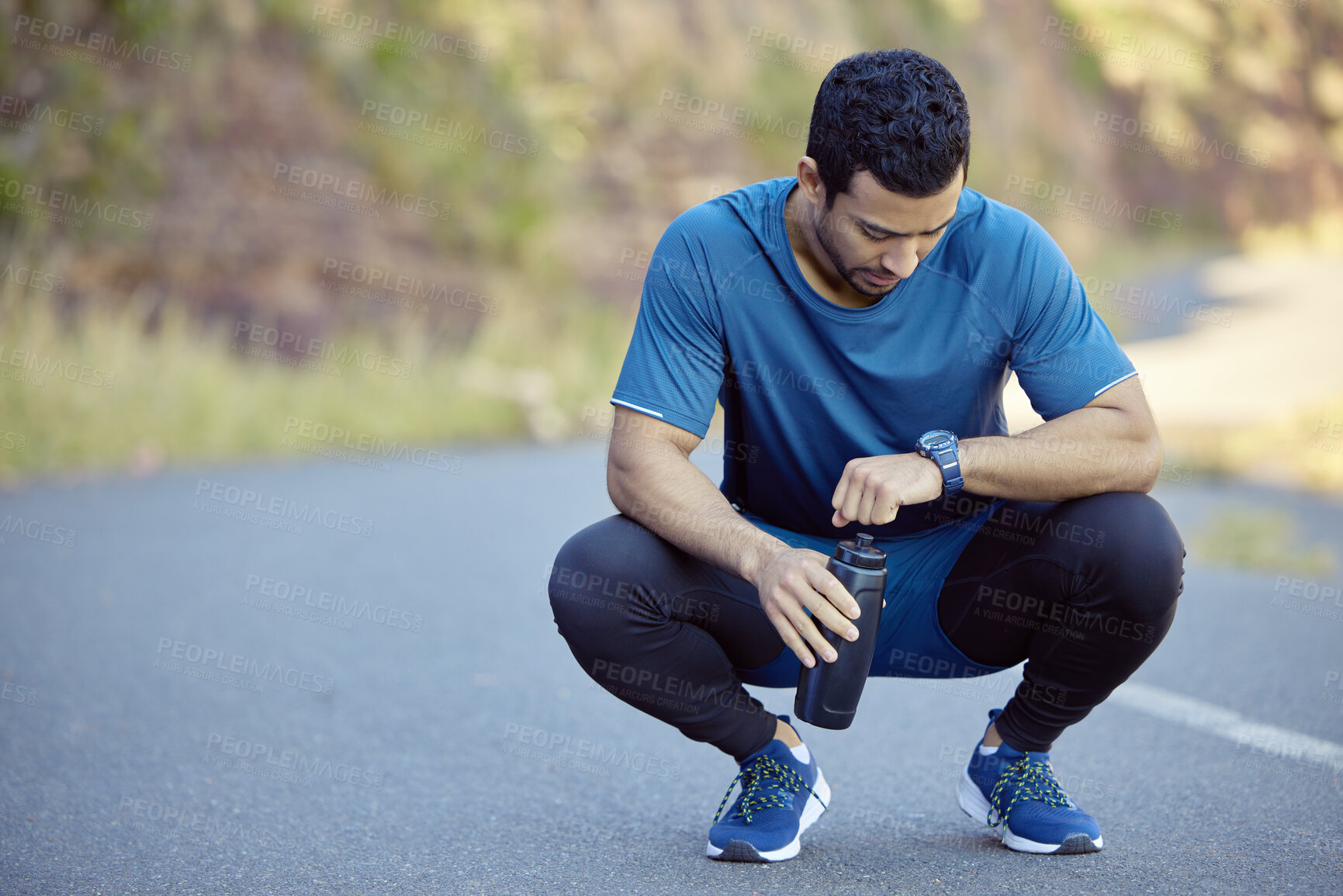 Buy stock photo Man, watch and tired athlete on break tracking training on mountain path for exercise, goals or check. Male person,  street and resting with heart rate pulse for marathon running, workout or healthy