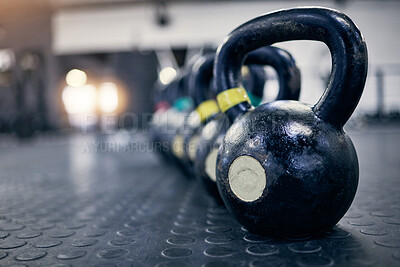 Buy stock photo Exercise, kettlebell and weights on floor of gym for training, wellness or workout with space. Background, metal equipment in health club and fitness for action, physical improvement or strength
