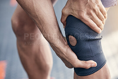 Buy stock photo Closeup shot of an unrecognisable man holding his knee in pain while exercising in a gym