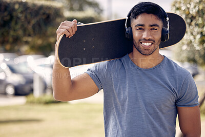 Buy stock photo Man, headphones and portrait with skateboard in park or music playlist, exercise or hobby. Male person, smile and streaming podcast for learning skill or fun workout for online, training or confident