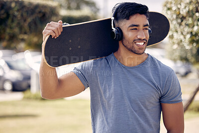 Buy stock photo Man, headphones and skateboard at outdoor park with relax thinking or music playlist, exercise or hobby. Male person, smile and streaming podcast for learning skill or fun workout, online or training