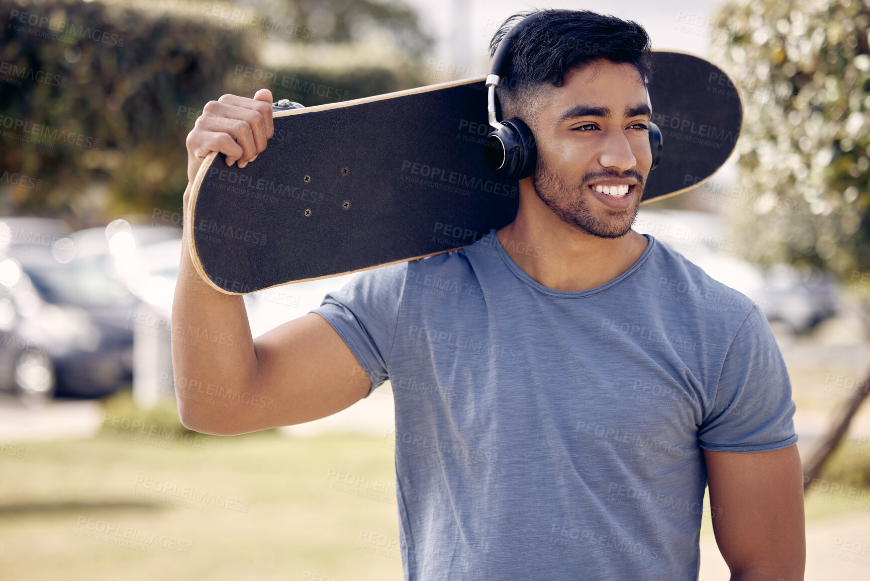 Buy stock photo Man, headphones and skateboard at outdoor park with relax thinking or music playlist, exercise or hobby. Male person, smile and streaming podcast for learning skill or fun workout, online or training