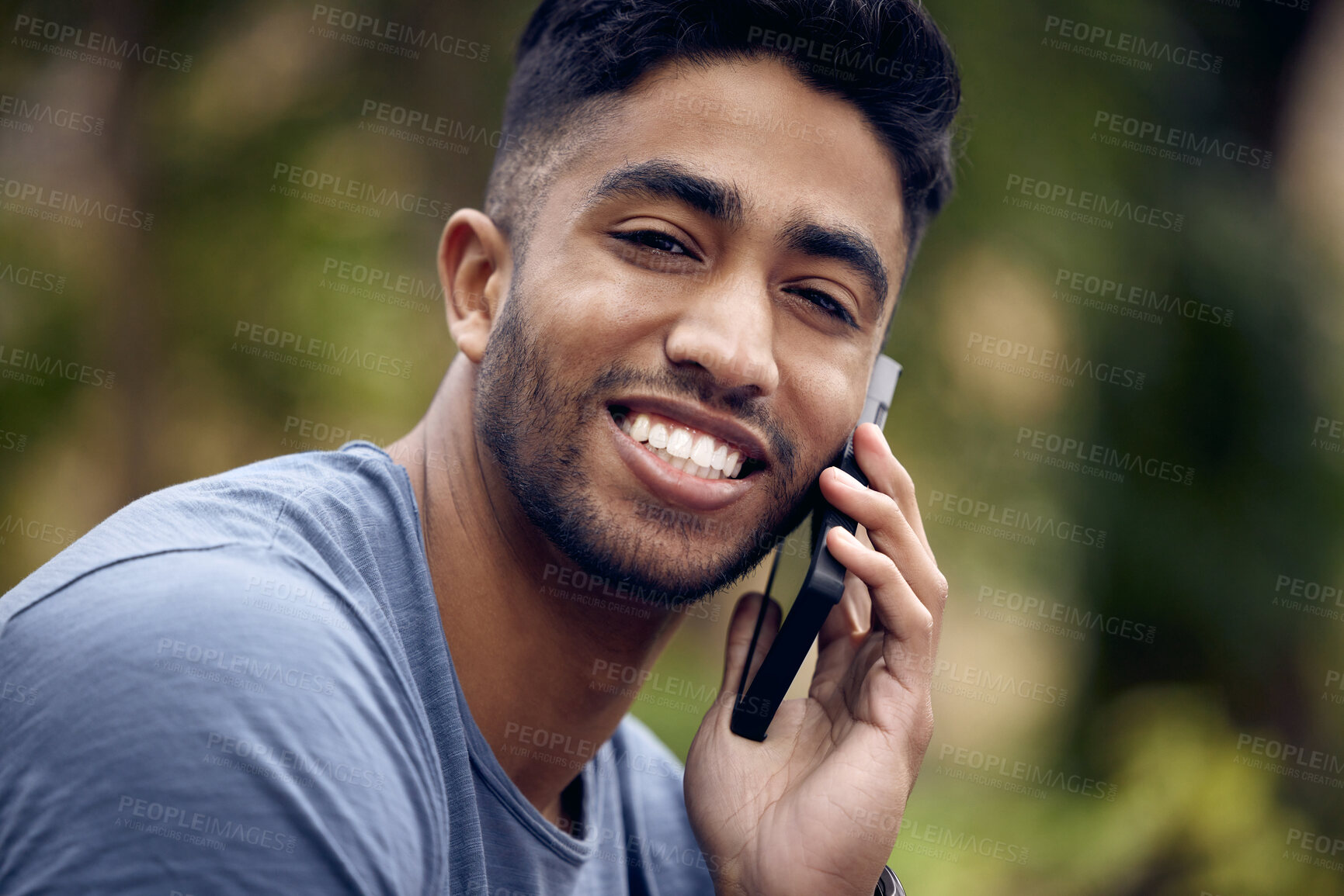 Buy stock photo Phone call, man and college student in park, portrait and smile with connection to contact and chat. University, education and person in campus with mobile, speaking and check for update in studying