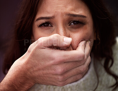 Buy stock photo Shot of a scared young woman’s mouth being covered by an unrecognisable man’s hand